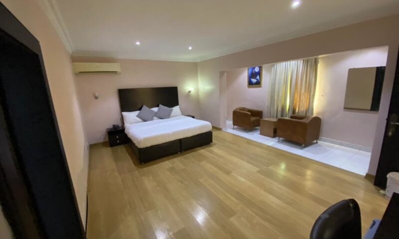 King bed and sitting area in the Deluxe Room at Heights Hotels Victoria Island