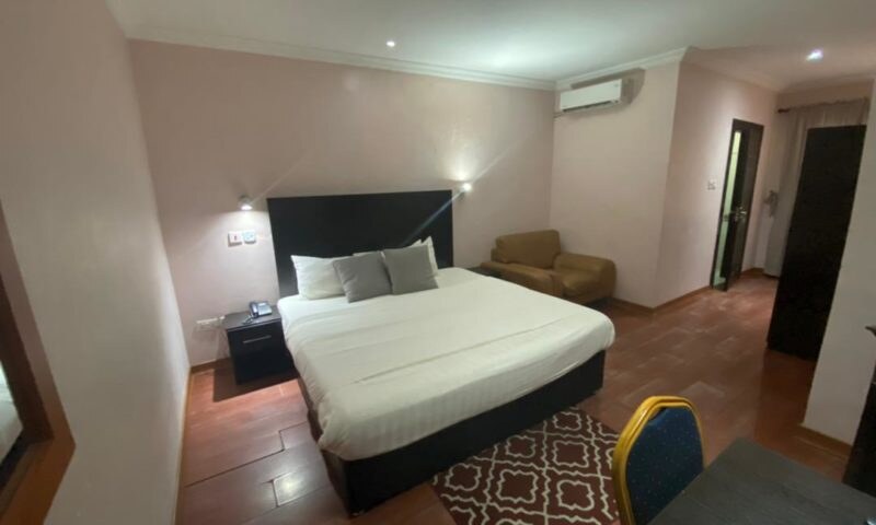 Queen bed and seating area in the Standard Room at Heights Hotels Victoria Island